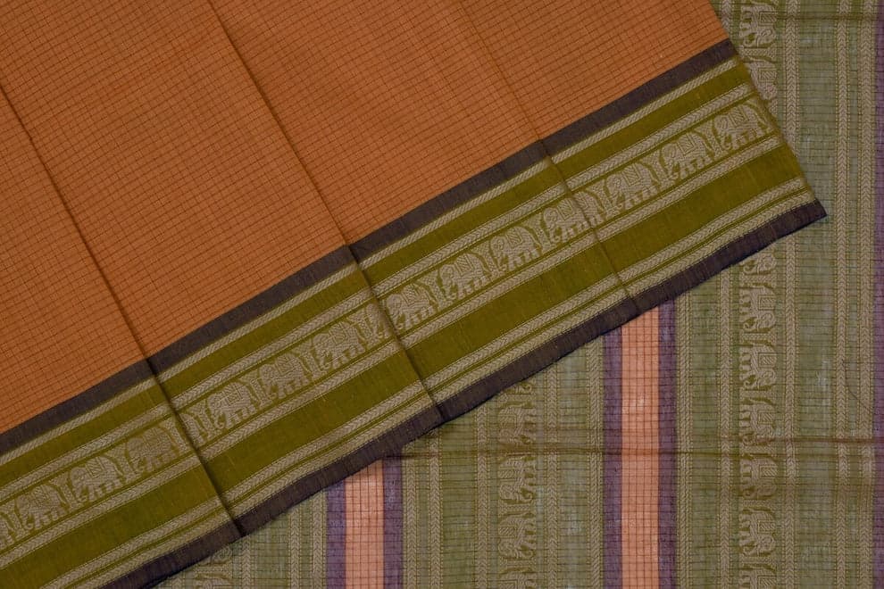 Close view of a handloom cotton saree: a checked rust-orange body meeting an olive-green border woven with elephant motifs